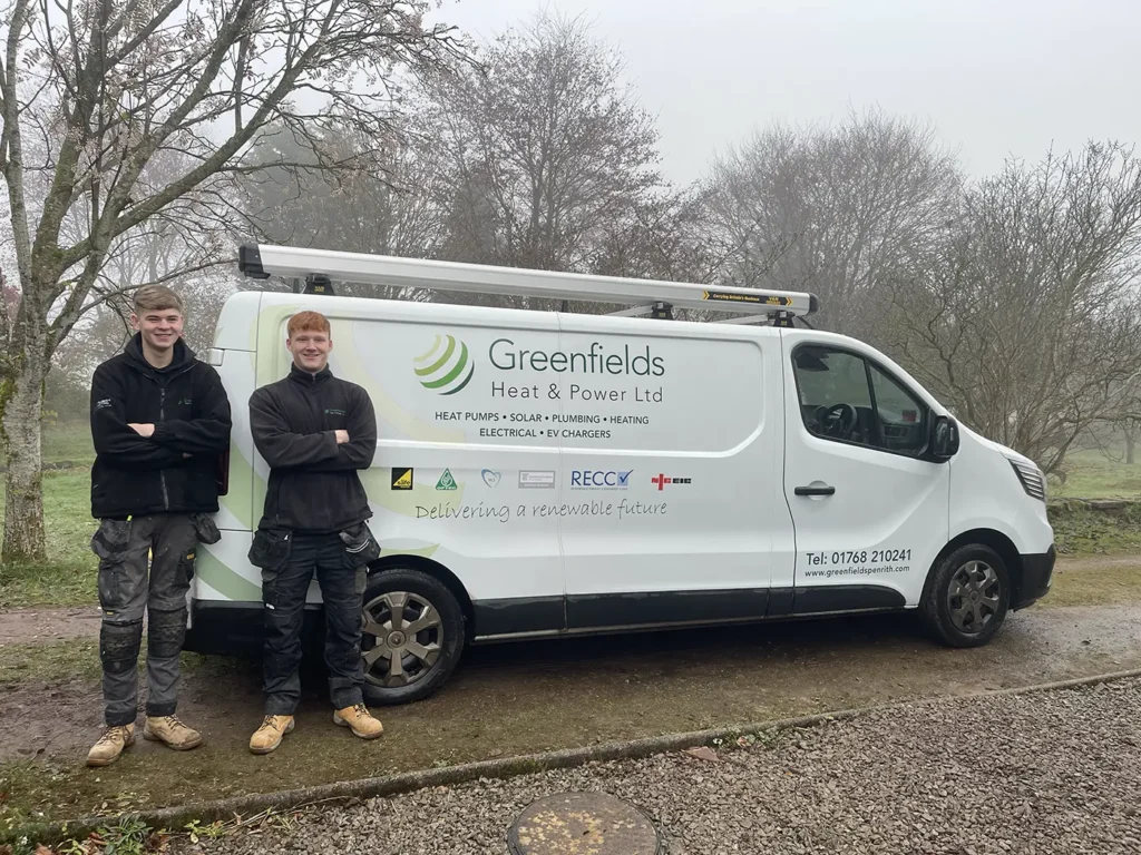 Two Greenfields team members stood in front of a Greenfields branded van.