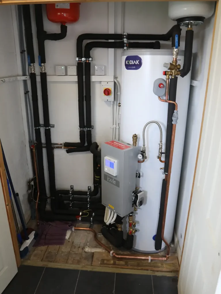 Kodiak domestic water tank installation with a Joule control unit, expansion vessel, and insulated pipework.