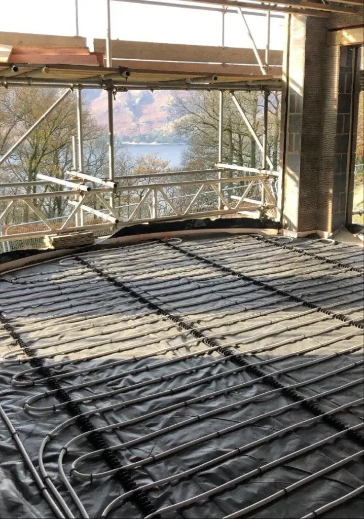 Underfloor heating installation in progress at a property with a scenic lake view