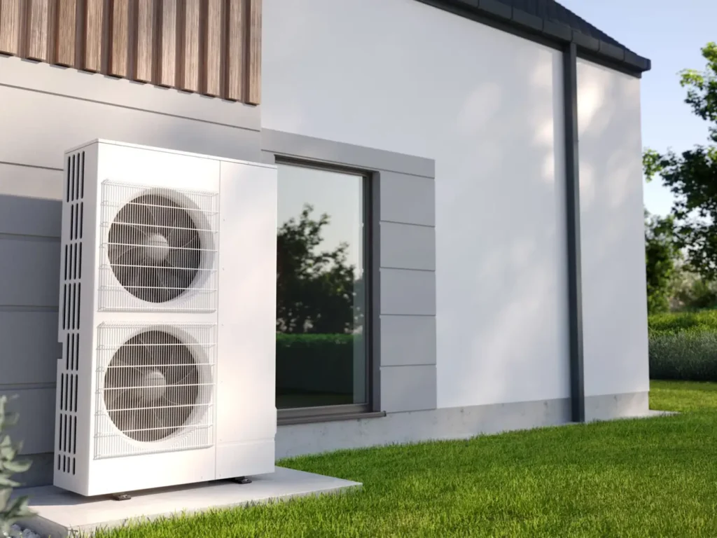 Modern air source heat pump unit installed outside a residential home for sustainable heating and cooling.